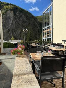 a restaurant with tables and chairs on a patio at Le Touring Hôtel restaurant in La Celle-sous-Gouzon