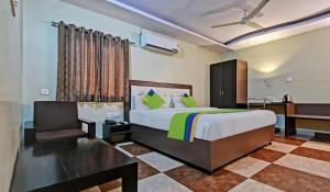 a bedroom with a large bed and a desk at Jaipur Grand Bella in Jaipur +29 photos