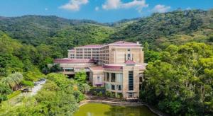an aerial view of a building in the middle of a mountain at The Lotus Villa Changan Dongguan in Dongguan