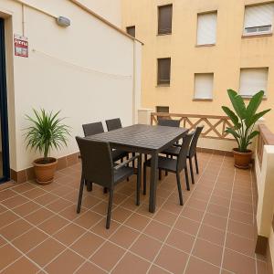 a black table and chairs on a patio at Hauzify I Can Xasil in Blanes
