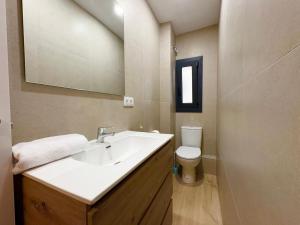a bathroom with a sink and a toilet at Hauzify I Can Xasil in Blanes +9 photos