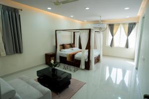 a living room with a bed and a mirror at Le Penguin Serviced Apartments in Madhapur