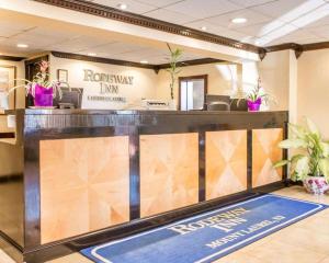 Rodeway Inn Mount Laurel Hwy 73 في Ramblewood: لوبى مع مكتب استقبال مع نباتات الفخار