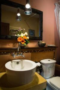 a bathroom with a sink and a mirror and a toilet at Phumorkdao Resort in Pong Yaeng +194 photos