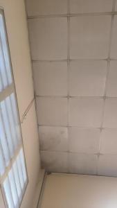 a room with a white tiled ceiling and a window at Shen kus to in Quy Nhon