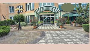 a entrance to a building with flowers in pots at Quartet-Quality Restauracja i Noclegi in Pniewy +10 photos