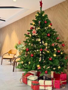 a christmas tree with presents under it in a room at Marone Suites Budapest in Budapest