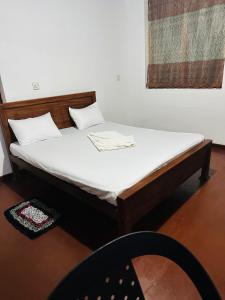 Ένα ή περισσότερα κρεβάτια σε δωμάτιο στο Pawana Hotel