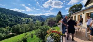 Chambre L'ORBI, Le Balcon de la Zimette في فينترون: مجموعة من الناس تقف على شرفة المنزل