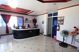 a living room with a kitchen and a counter at Aizawa Beach Resort in Santiago