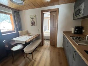 a small kitchen with a table and a dining room at Nonas B&B in Galtür
