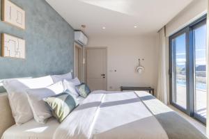 a bedroom with a large bed with a large window at Sella Verde in Selina +35 photos