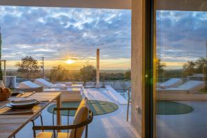 a patio with a table and chairs and a pool at Sella Verde in Selina