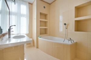 a bathroom with a tub and a sink at Imperial Apartments - Classic in Sopot