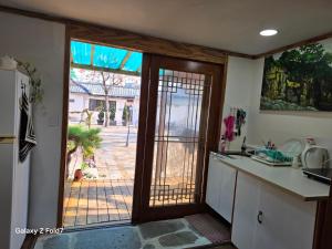a kitchen with a door open to a yard at 서라벌옛집 in Gyeongju