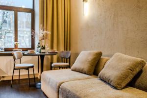 a living room with a couch and a table at Central Park Apartments - The Luxury Collection in Kaunas