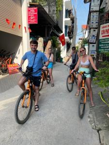 a group of people riding bikes down a street at Center Tam Coc Homestay in Ninh Binh