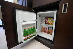 an open refrigerator filled with drinks and food at Visse Hotel in Mudanya