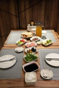 a table with plates of food on it at Visse Hotel in Mudanya