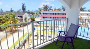 Una silla azul en un balcón con vista a un edificio. en Blue Saipan Garden, en Susupe 69 fotos más