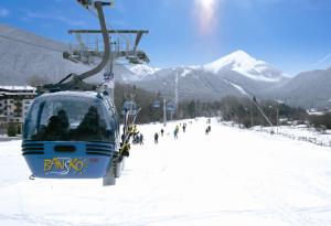 a ski lift with skiers on a snow covered mountain at Katy's studio in Bansko