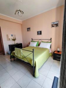 a bedroom with a green bed and a chair at La Playa di Ponente in Cagliari