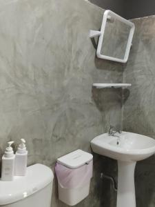 a bathroom with a sink and a toilet and a mirror at DD Beach Houses in Phra Ae beach +63 photos