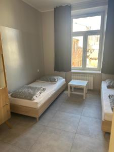 a bedroom with two beds and a table in it at StarBal in Radom +14 photos