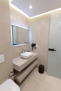 a bathroom with a sink and a mirror at Velura Hotel in Ferizaj +151 photos