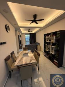 a dining room with a table and a ceiling fan at Ash Royale Suite - Bercham 138, Bandar Baru Putra, Ipoh, Perak in Kampong Batu Lapan