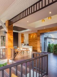 a living room with a staircase and a dining room at Lipda Resort in Ban Nong Hin
