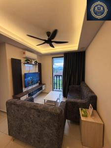 a living room with a couch and a ceiling fan at Ash Royale Suite - Bercham 138, Bandar Baru Putra, Ipoh, Perak in Kampong Batu Lapan +19 photos
