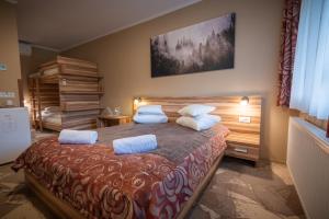 a bedroom with a large bed with two pillows at Németh Resort in Sovata +65 photos