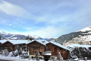 a log cabin in the mountains with snow on it at Bruyères B22 in Verbier