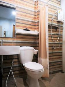 a bathroom with a toilet and a sink at The Lofts Eco Resort in Ban Kut Khamin