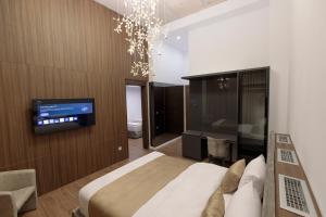 a bedroom with a bed and a tv on a wall at Velura Hotel & Spa in Ferizaj +245 photos