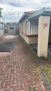 a house with a brick driveway in front of it at Tesco Accommodation in Gqeberha