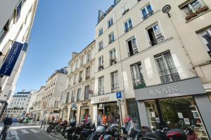 a group of motorcycles parked in front of a building at Sweet Inn - Aboukir II in Paris