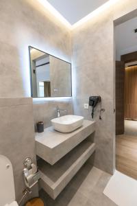 a bathroom with a sink and a mirror at Velura Hotel & Spa in Ferizaj