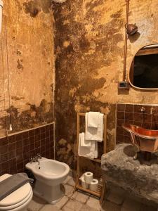 a dirty bathroom with a sink and a toilet at Paolino848 in Trentinara