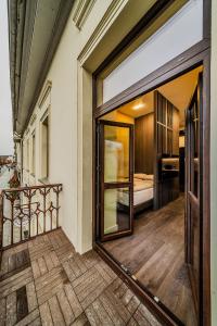 an open door to a balcony with a bedroom at Central Park Apartments - The Luxury Collection in Kaunas