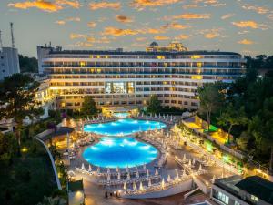 a hotel with a large pool in front of it at A Good Life Utopia Family Resort in Alanya