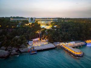 an aerial view of a resort on the water at night at A Good Life Utopia Family Resort in Alanya