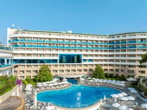 a hotel with a swimming pool and chairs and a building at A Good Life Utopia Family Resort in Alanya +56 photos