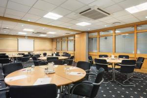 a conference room with tables and chairs and a whiteboard at Garner Hotel Nottingham City Centre by IHG in Nottingham