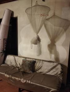 een bank in een kamer met een muur met gordijnen bij Light Worker Guest House room number 0 in Phra Ae beach