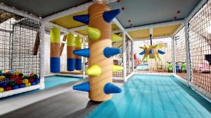 a indoor pool with a slide and a playground at Hotel Kocourkov in Hlinsko