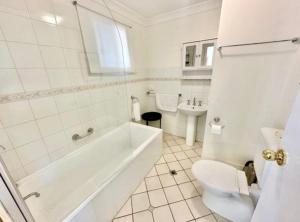 a bathroom with a tub and a toilet and a sink at Beautiful Heritage Style Room in York in York