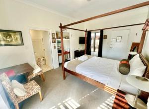 a bedroom with a bed and a table and chairs at Beautiful Heritage Style Room in York in York