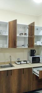 a kitchen with a sink and a microwave at Résidence touristique marcadal in Fort de lʼEau